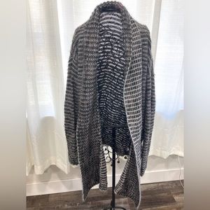 Woman’s shawl sweater. Sits at waist/thigh. Sewn in pockets. Wool, one size